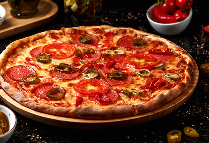 pepperoni pizza with olives on wooden board